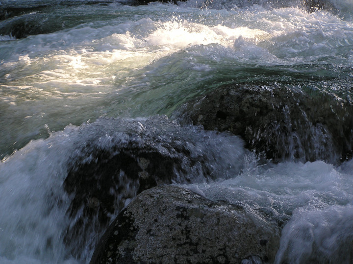 Photo of boulders with
                                          water rushing over them in a
                                          mountain creek