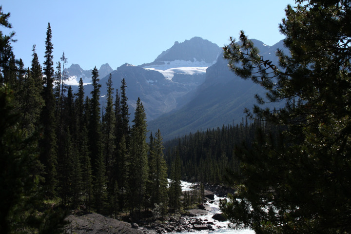 Photo of a mountain
                                          landscape with trees, a river,
                                          and mountains in the
                                          background